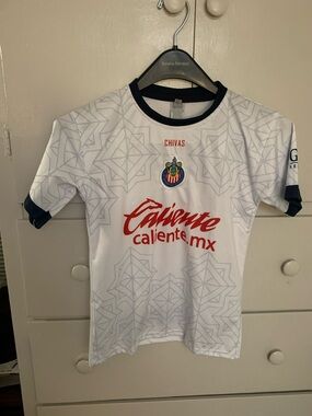 Civas Kids White Jersey with Navy Trim and Red Sponsor Logo